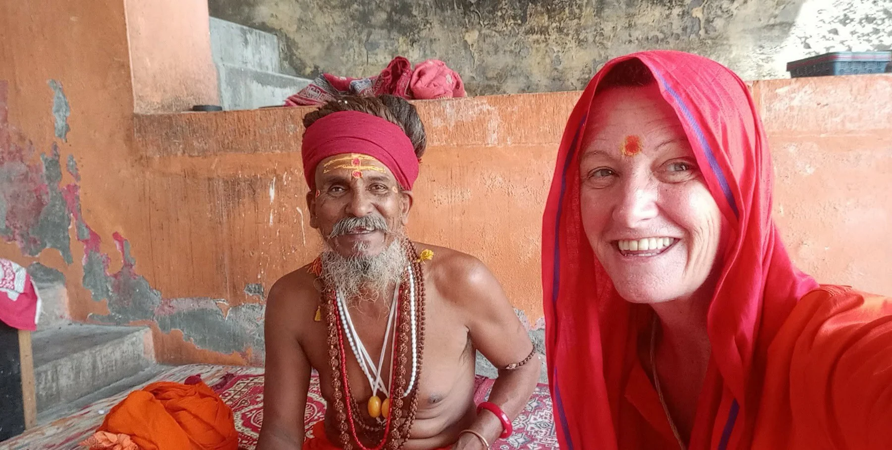 A woman and a man sitting together in a room with painted walls