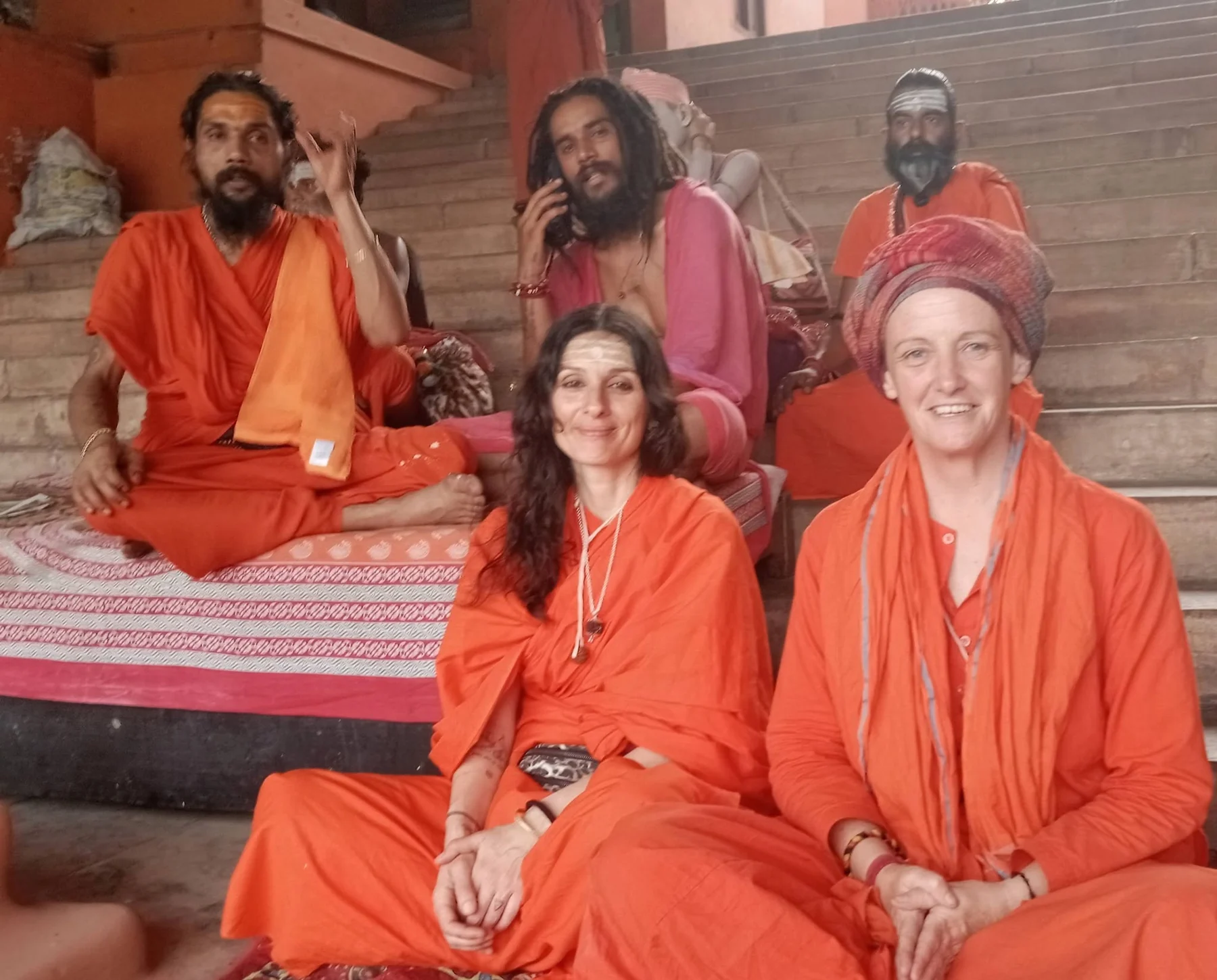 A group sitting together on a covered floor