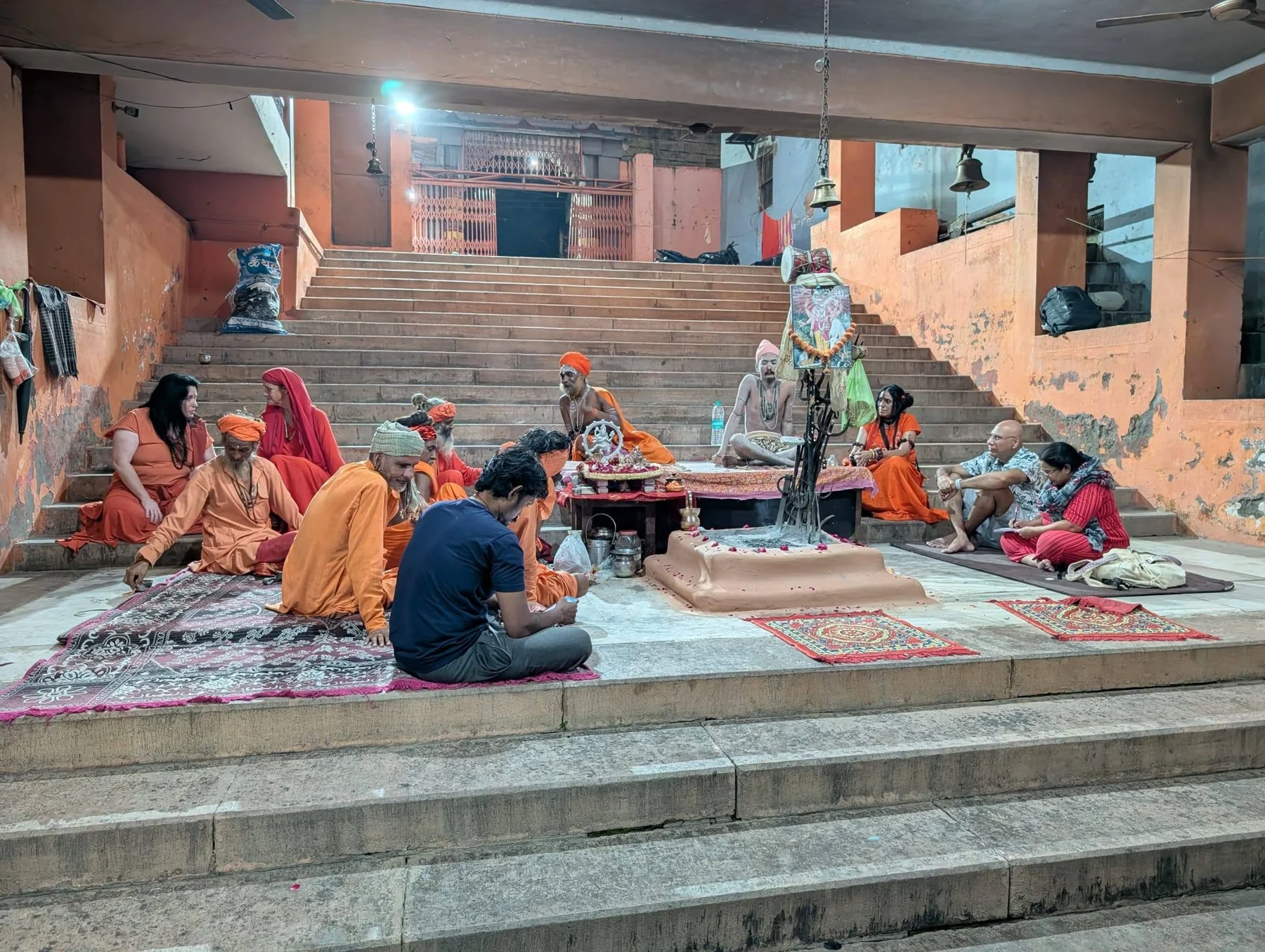 A group seated around a courtyard gathering